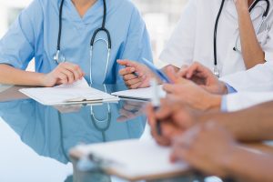 Mid section group of young doctors in a meeting at hospital