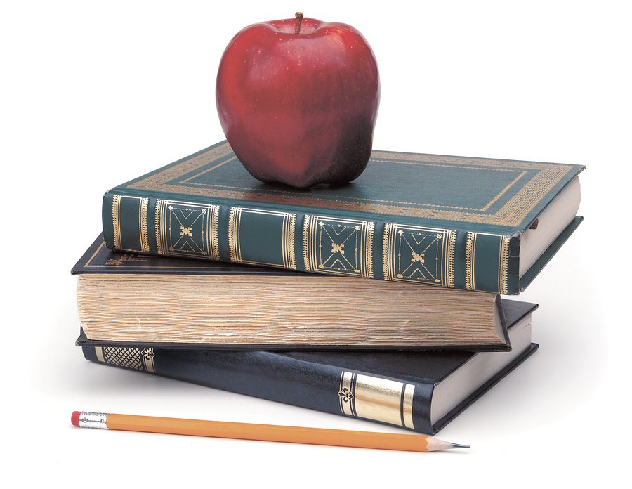 books, pencil, apple on white