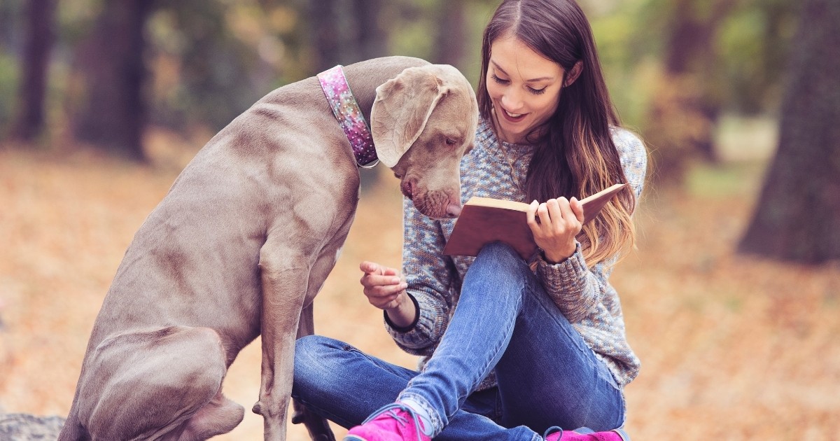 woman and dog reading book